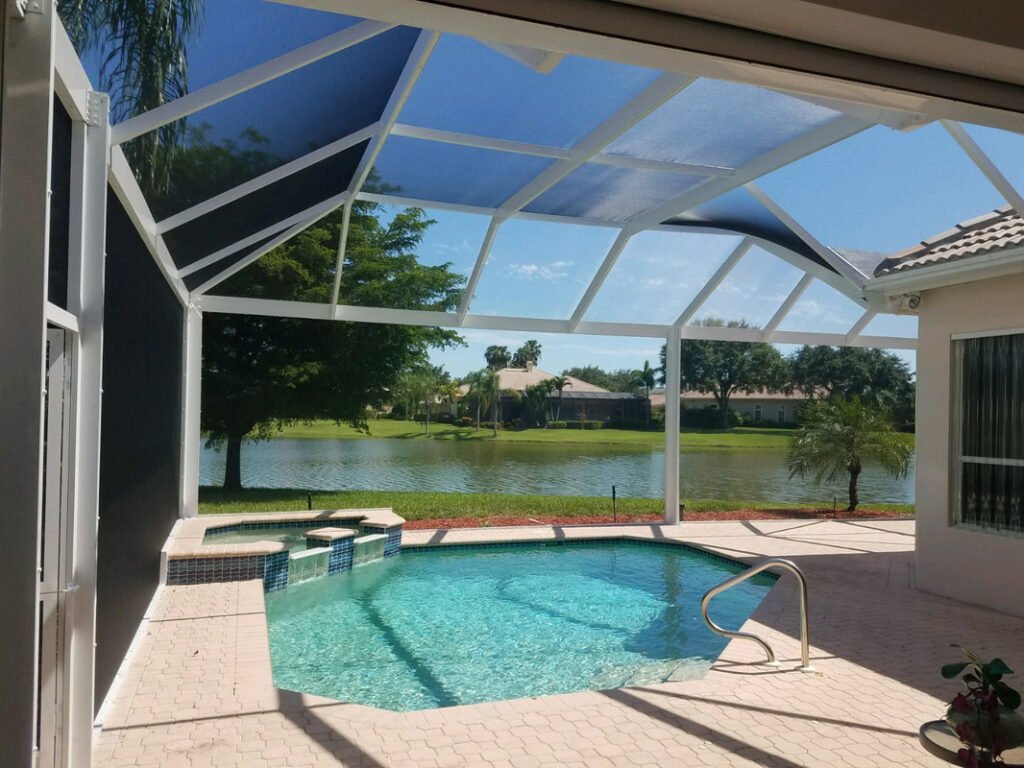 Pool enclosure rescreening in Winter Haven, FL with clear panels over backyard pool
